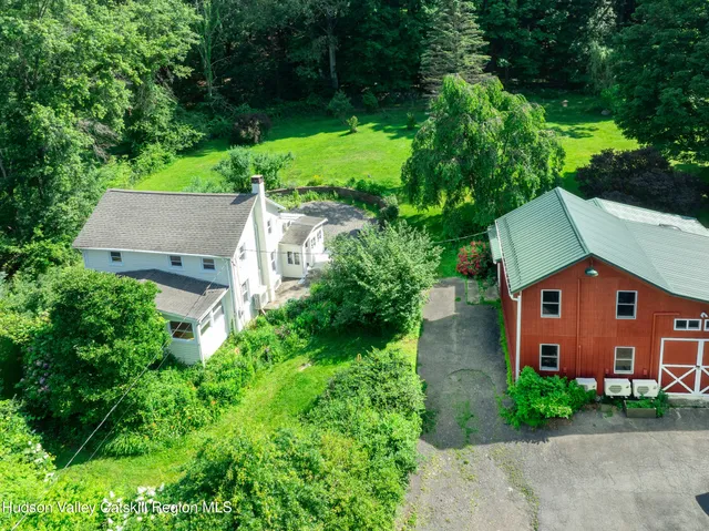 an aerial view of a house with a yard