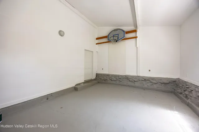 an empty room with windows and wooden floor