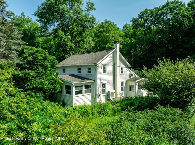 a aerial view of a house with yard and green space