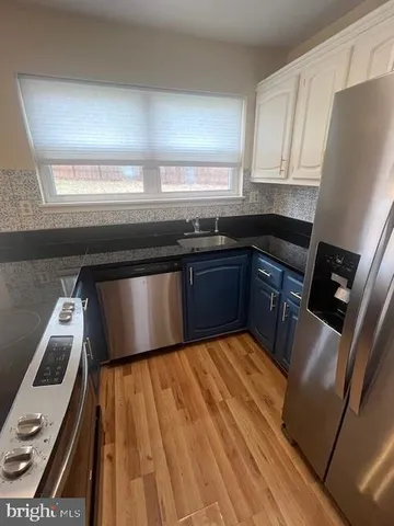 a kitchen with granite countertop cabinets sink and window