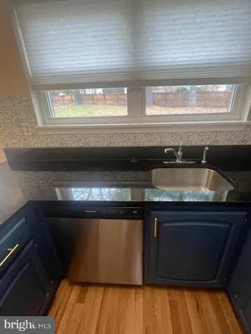 a living room with a bed furniture and a wooden floor