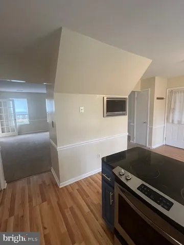 a kitchen with granite countertop a refrigerator and a sink