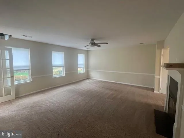 a view of empty room with a fireplace