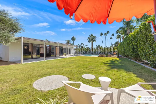 a view of a swimming pool with an outdoor seating