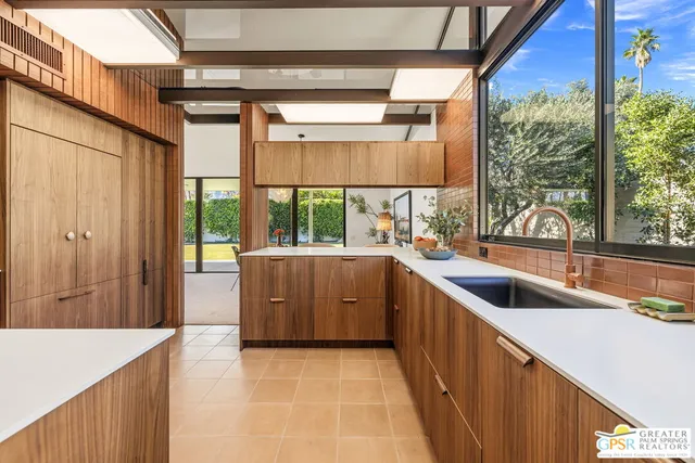 a view of a kitchen with a sink and large cabinets