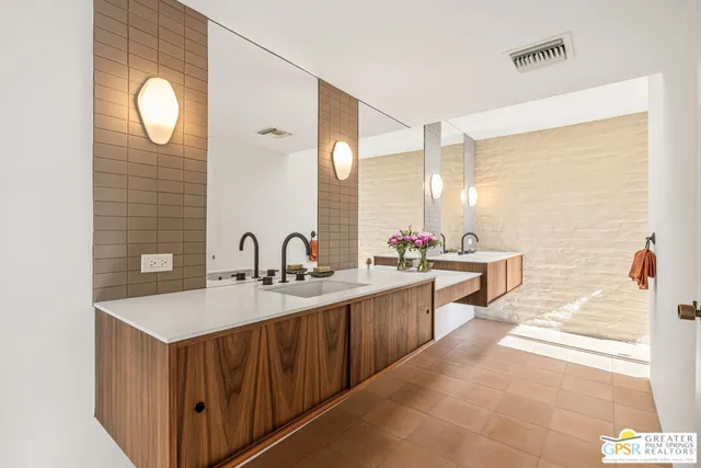 a bathroom with a sink a vanity and a mirror