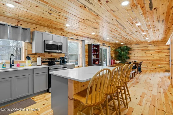 a kitchen with a sink a stove and cabinets