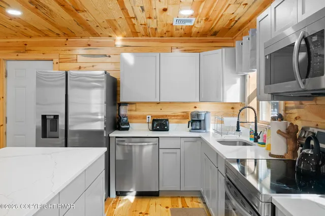 a bathroom with a sink vanity mirror and toilet