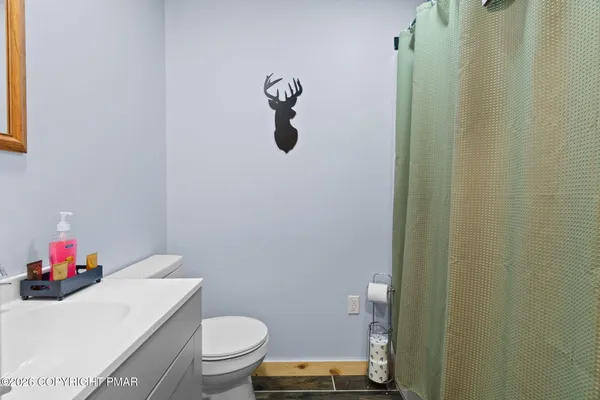 a bedroom with a bed and a wooden floor