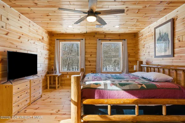 a bedroom with a bed and a chandelier