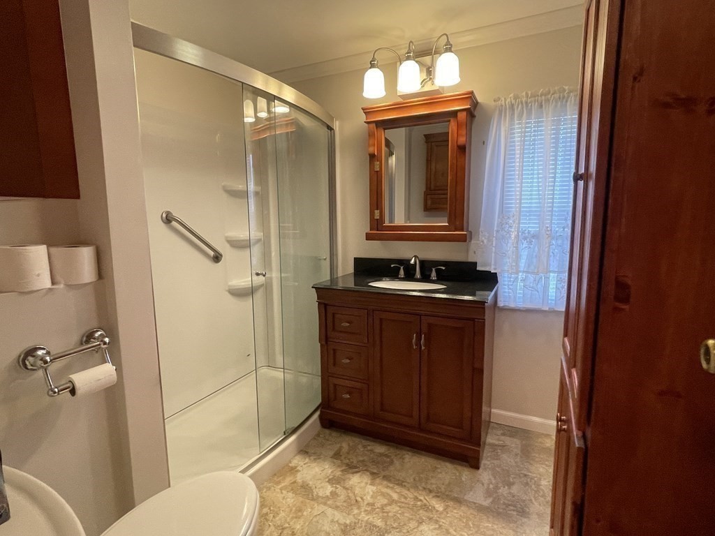 239 Ayer Road, Unit 49 Littleton, MA 01460 - Photo 13 of 21 a bathroom with a toilet a sink and mirror