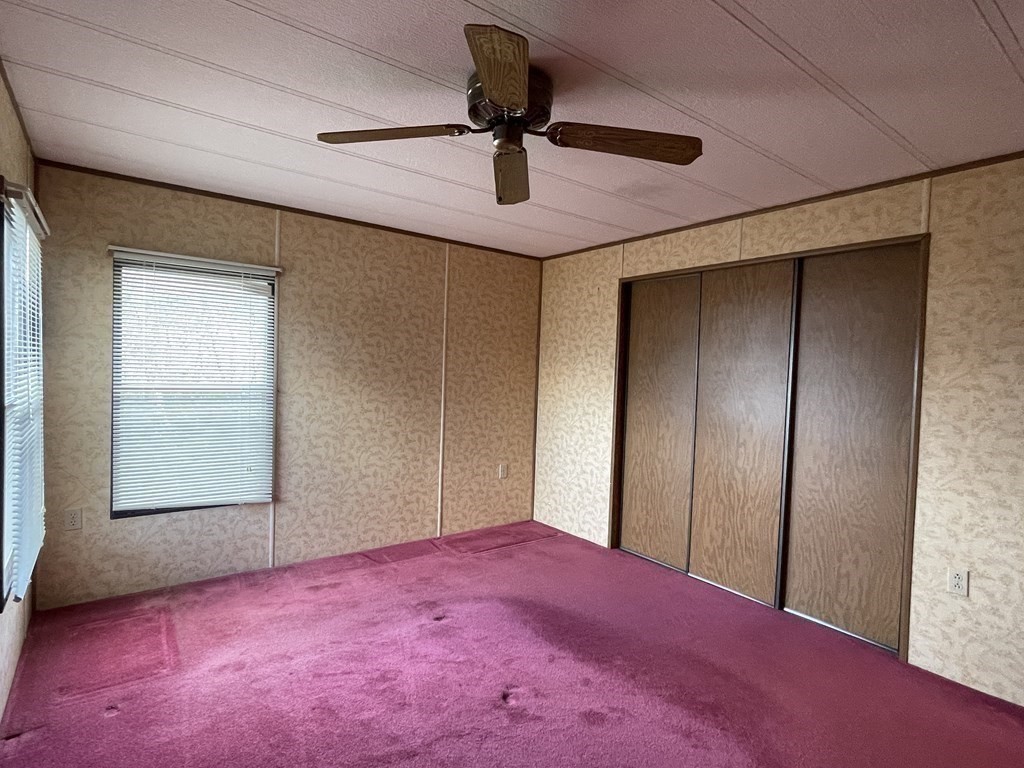 239 Ayer Road, Unit 49 Littleton, MA 01460 - Photo 18 of 21 an empty room with windows and ceiling fan