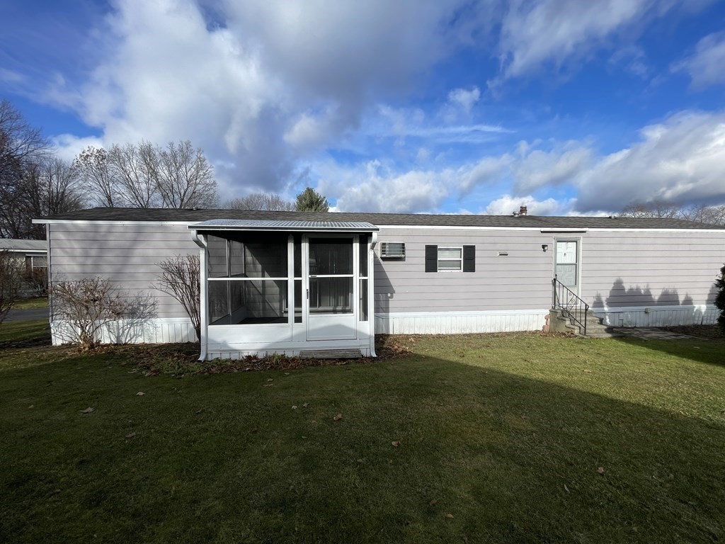 239 Ayer Road, Unit 49 Littleton, MA 01460 - Photo 4 of 21 a view of a back yard of the house with green space