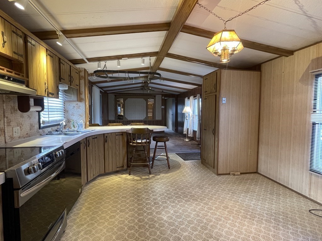 239 Ayer Road, Unit 49 Littleton, MA 01460 - Photo 6 of 21 a kitchen with stainless steel appliances granite countertop a stove and a refrigerator