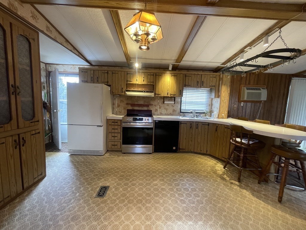 239 Ayer Road, Unit 49 Littleton, MA 01460 - Photo 7 of 21 a kitchen with stainless steel appliances granite countertop a sink a stove and a refrigerator
