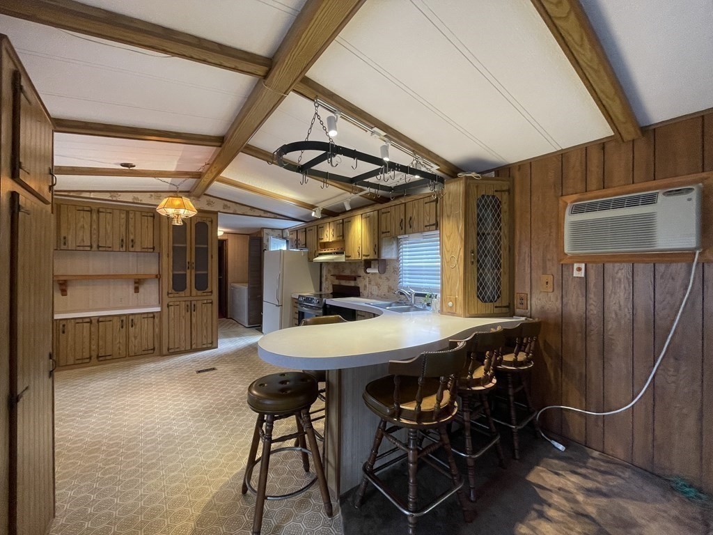 239 Ayer Road, Unit 49 Littleton, MA 01460 - Photo 9 of 21 a view of a dining room with furniture window and wooden floor
