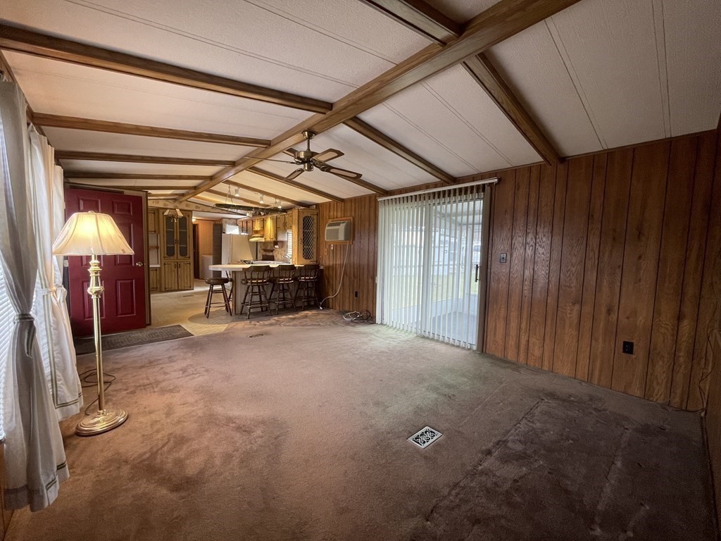 239 Ayer Road, Unit 49 Littleton, MA 01460 - Photo 10 of 21 a view of a room with wooden walls and gym equipment