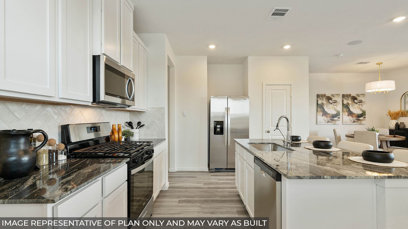 232 Flying Tigers Trail Jarrell, TX 76537 - Photo 2 of 22 a kitchen with stainless steel appliances granite countertop a sink stove and refrigerator
