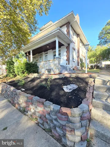 a view of a patio with table and chairs and wooden fence
