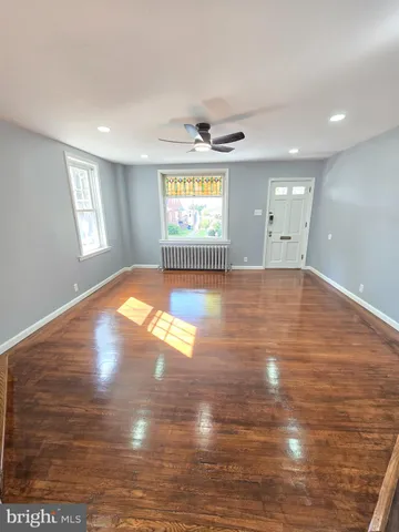 a view of an entryway with wooden floor