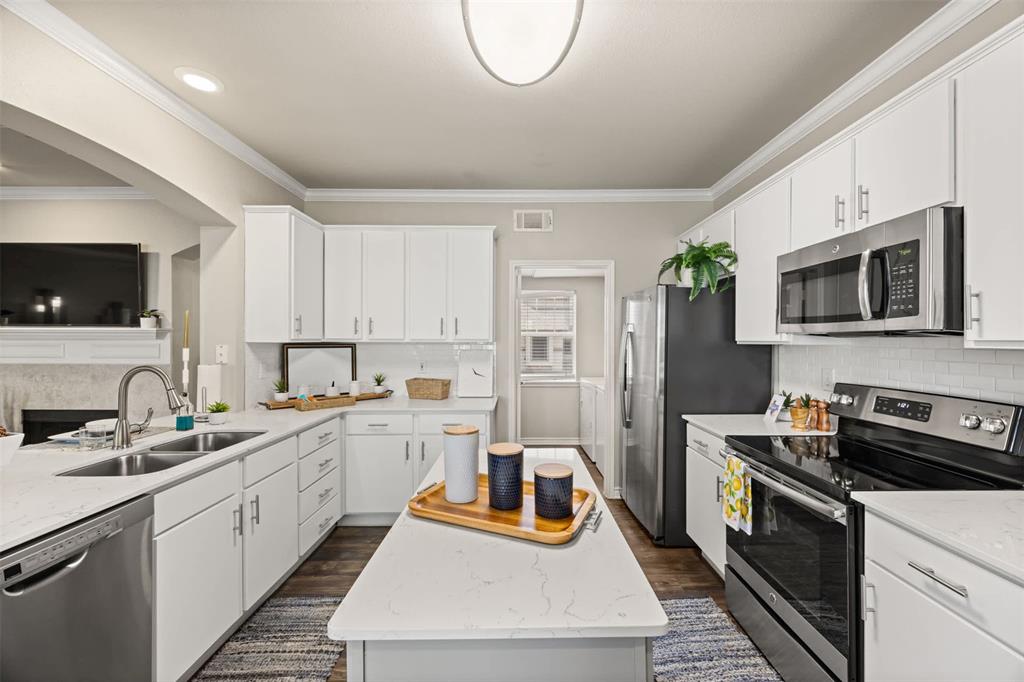 9009 North FM 620, Unit 702 Austin, TX 78726 - Photo 8 of 19 a kitchen with a sink a stove and cabinets