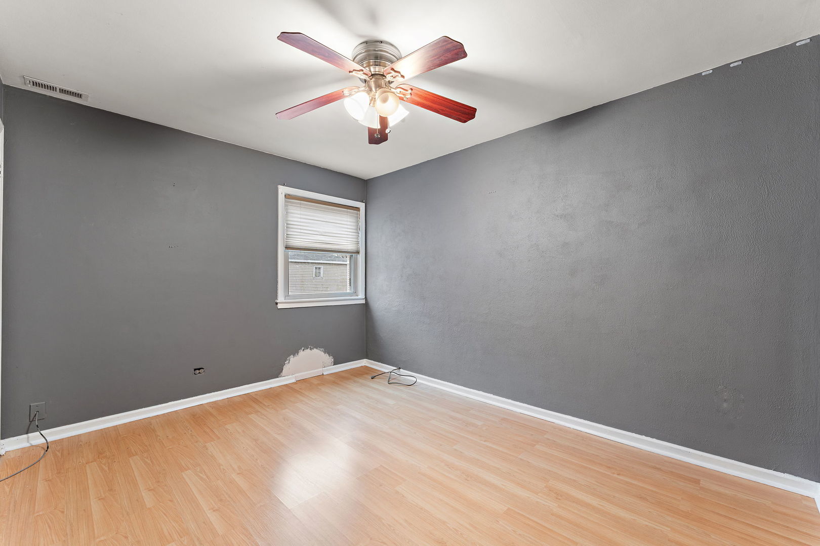 3520 Jackson Street Lansing, IL 60438 - Photo 12 of 22 a view of a big room with wooden floor and a ceiling fan