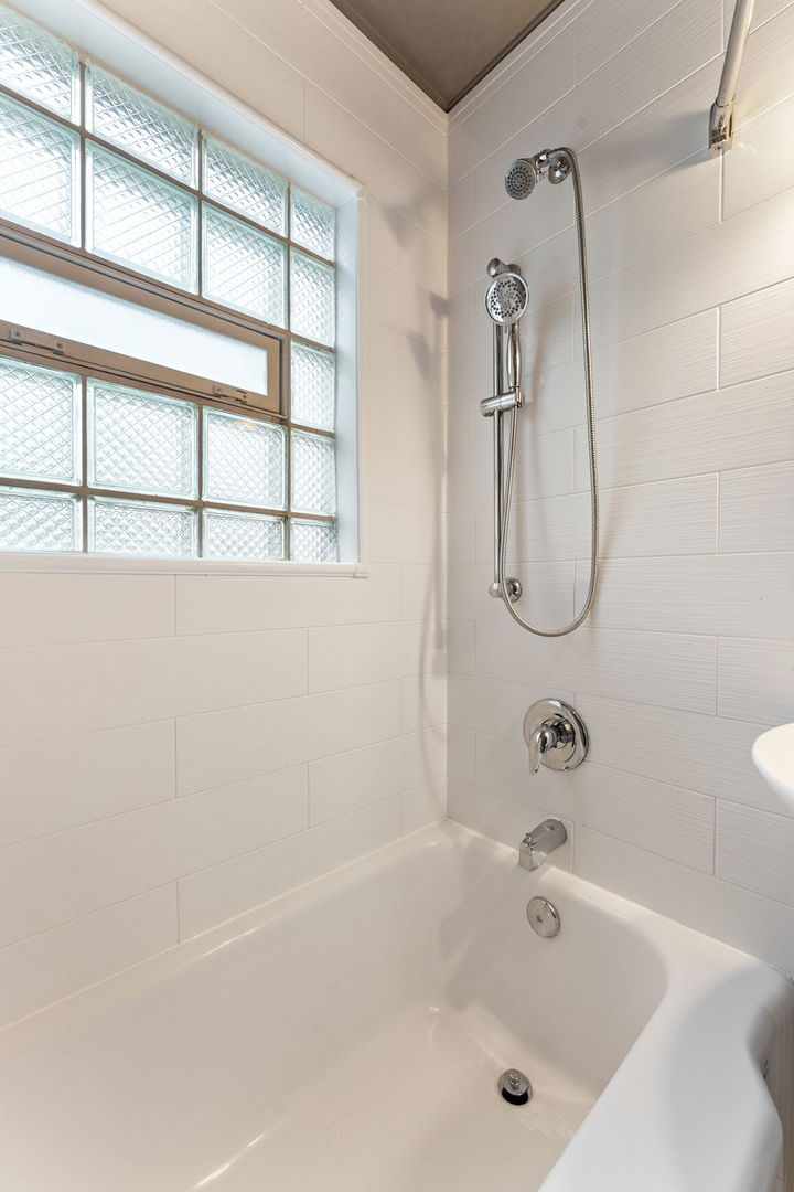 3520 Jackson Street Lansing, IL 60438 - Photo 20 of 22 a bathroom with a bath tub and a shower