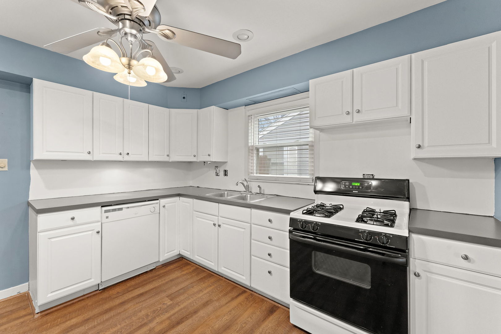 3520 Jackson Street Lansing, IL 60438 - Photo 6 of 22 a kitchen with granite countertop white cabinets and white appliances
