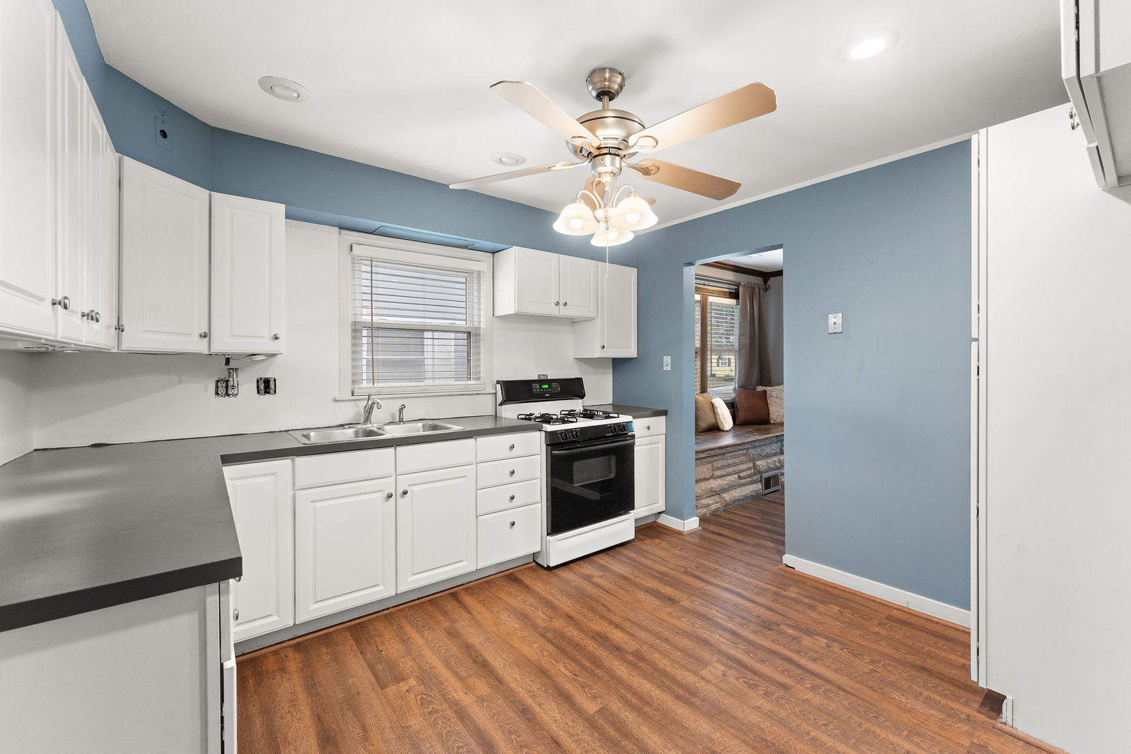 3520 Jackson Street Lansing, IL 60438 - Photo 7 of 22 a kitchen with a white cabinets and window