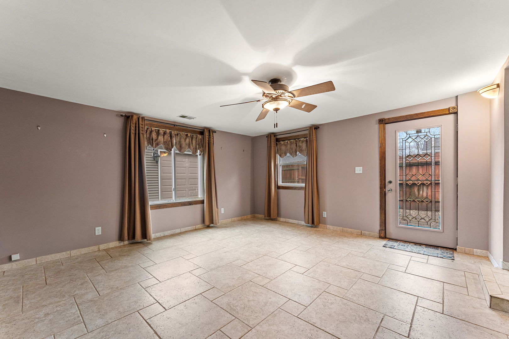 3520 Jackson Street Lansing, IL 60438 - Photo 9 of 22 a view of a livingroom with a chandelier fan and windows