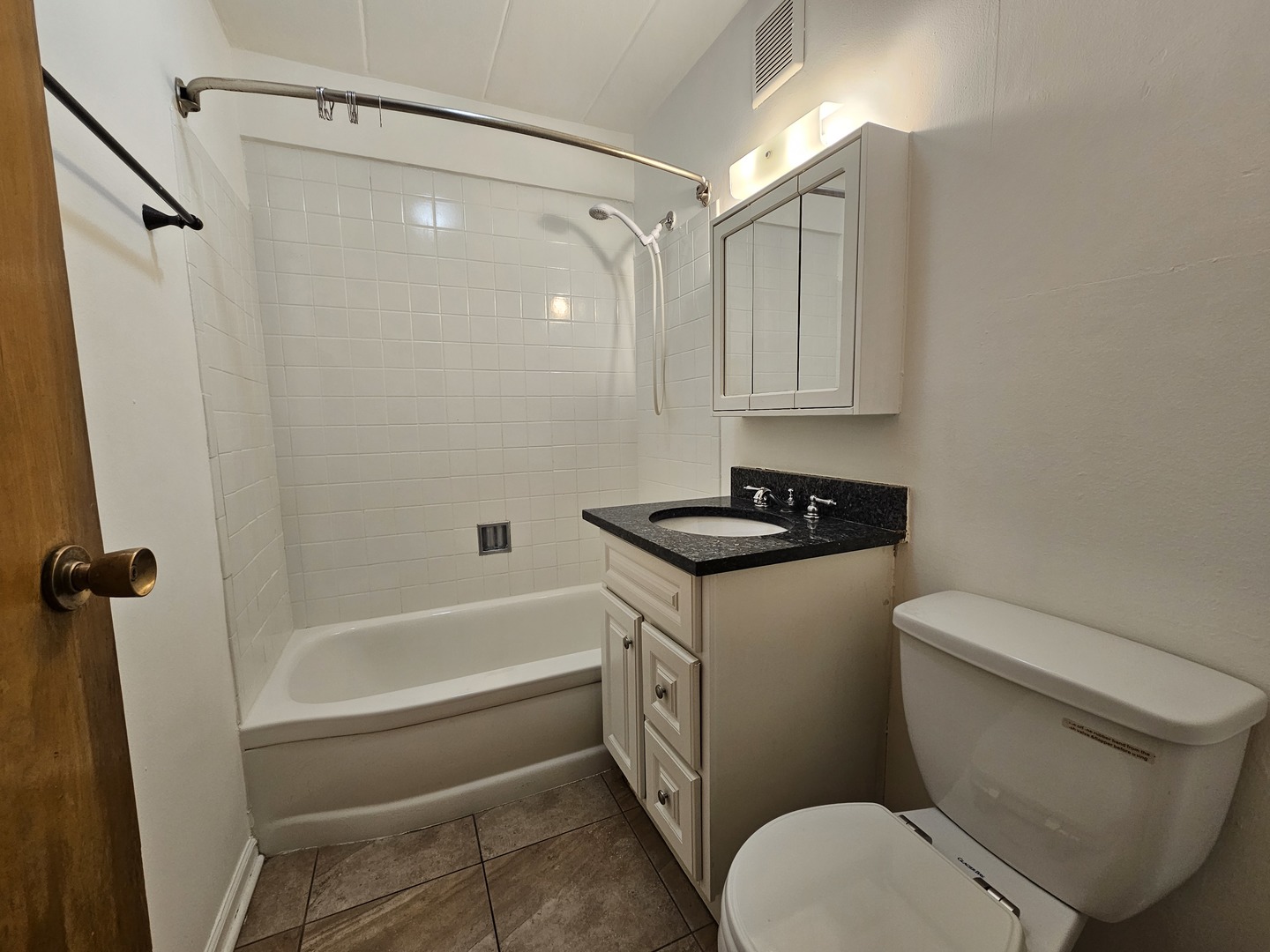 5906 North Sheridan Road, Unit 4A Chicago, IL 60660 - Photo 14 of 15 a bathroom with a granite countertop sink toilet and shower