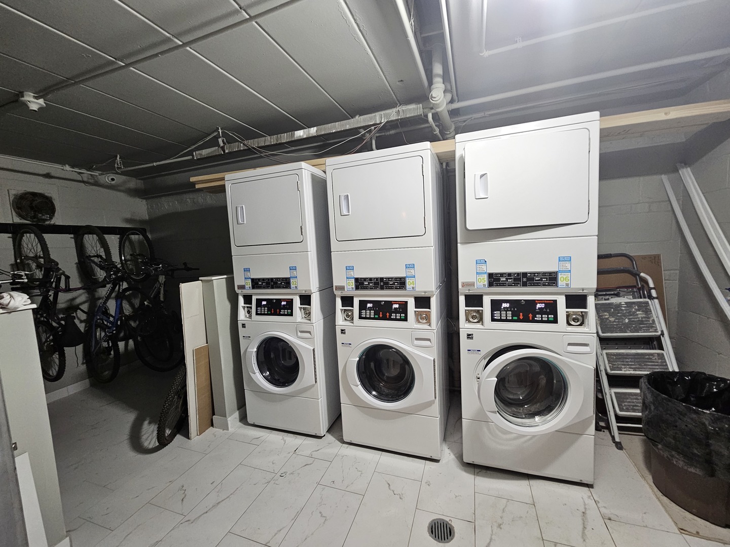 5906 North Sheridan Road, Unit 4A Chicago, IL 60660 - Photo 15 of 15 a utility room with dryer washer and racks