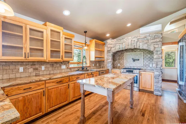 a kitchen with a table chairs sink and cabinets