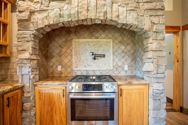 a stove top oven sitting inside of a kitchen