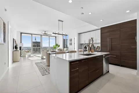 a living room with furniture a flat screen tv and a large window