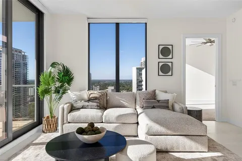 a living room with furniture a rug and a flat screen tv