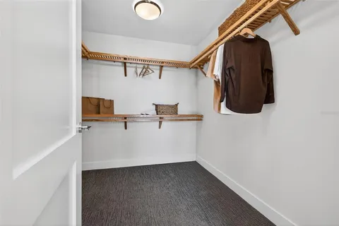 a view of a room with wooden floor and windows