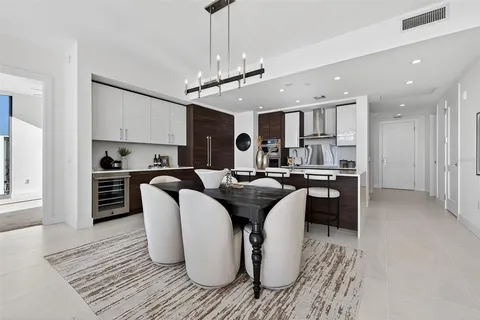 a kitchen with stainless steel appliances granite countertop a sink and a refrigerator
