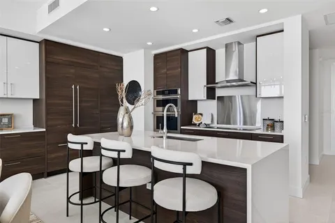 a kitchen with stainless steel appliances granite countertop a sink dishwasher stove and cabinets