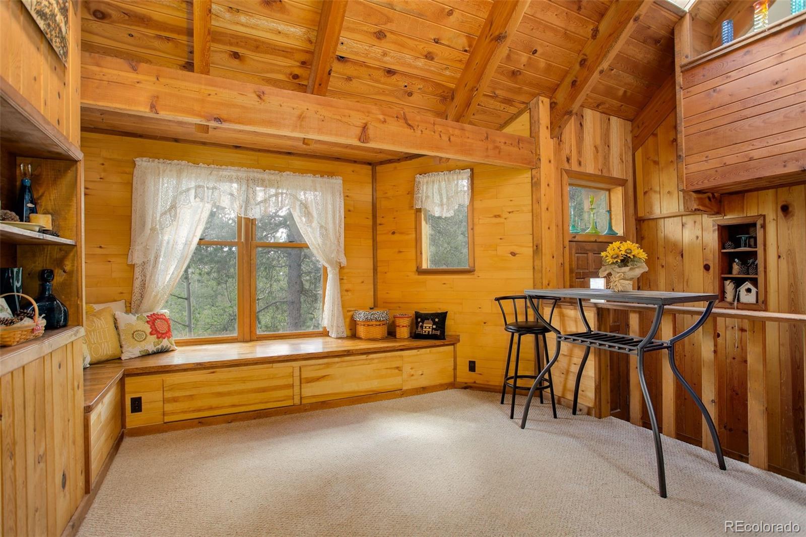 77 East Crosscut Road Bailey, CO 80421 - Photo 1 of 43 a room with table and chairs