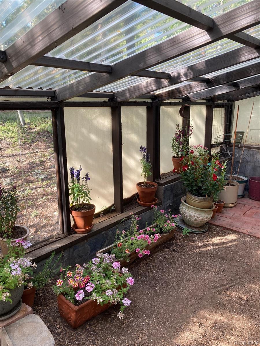 77 East Crosscut Road Bailey, CO 80421 - Photo 15 of 43 a room with lots of flowers and a table