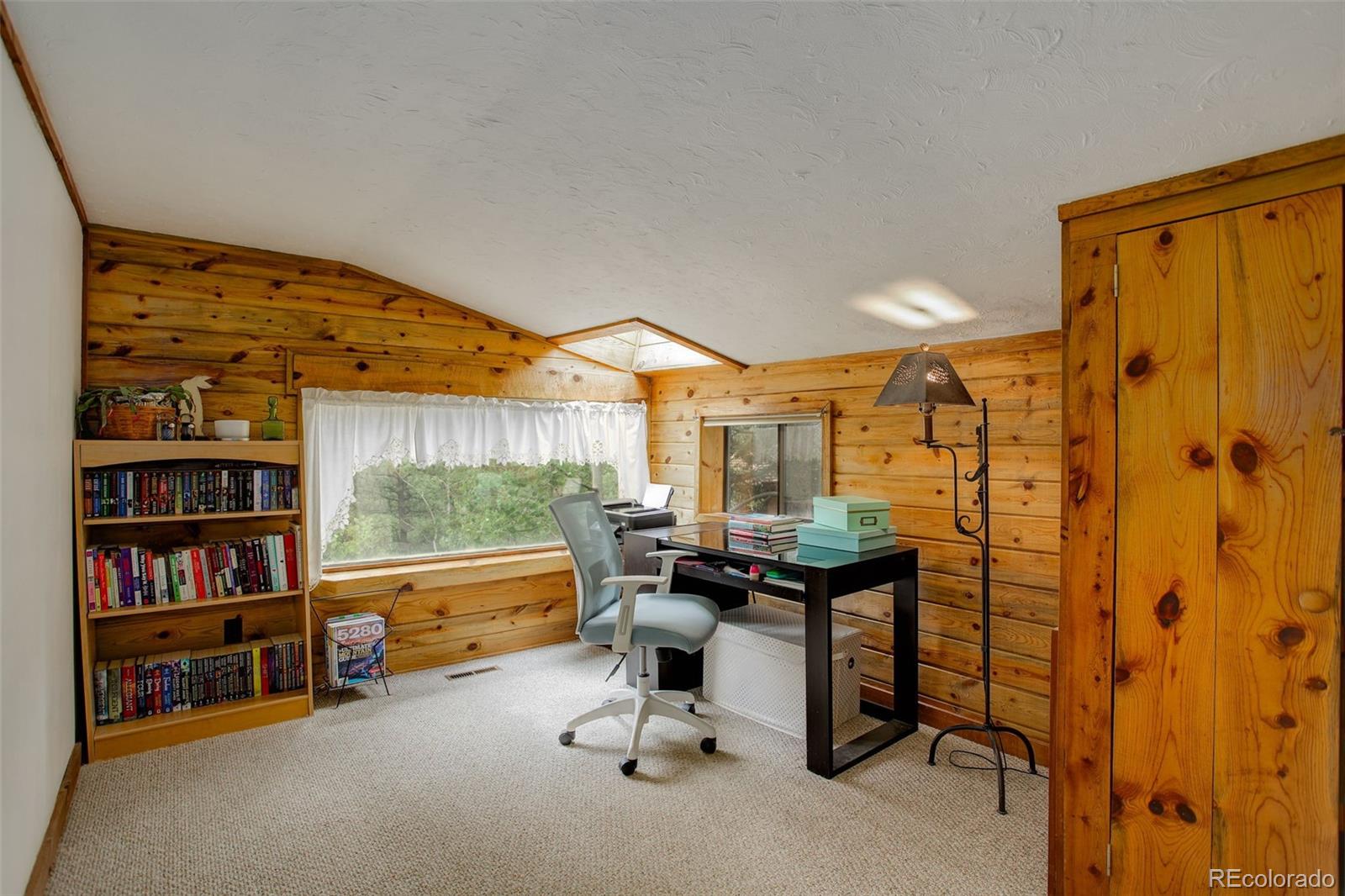 77 East Crosscut Road Bailey, CO 80421 - Photo 30 of 43 a reading room with furniture and a book shelf