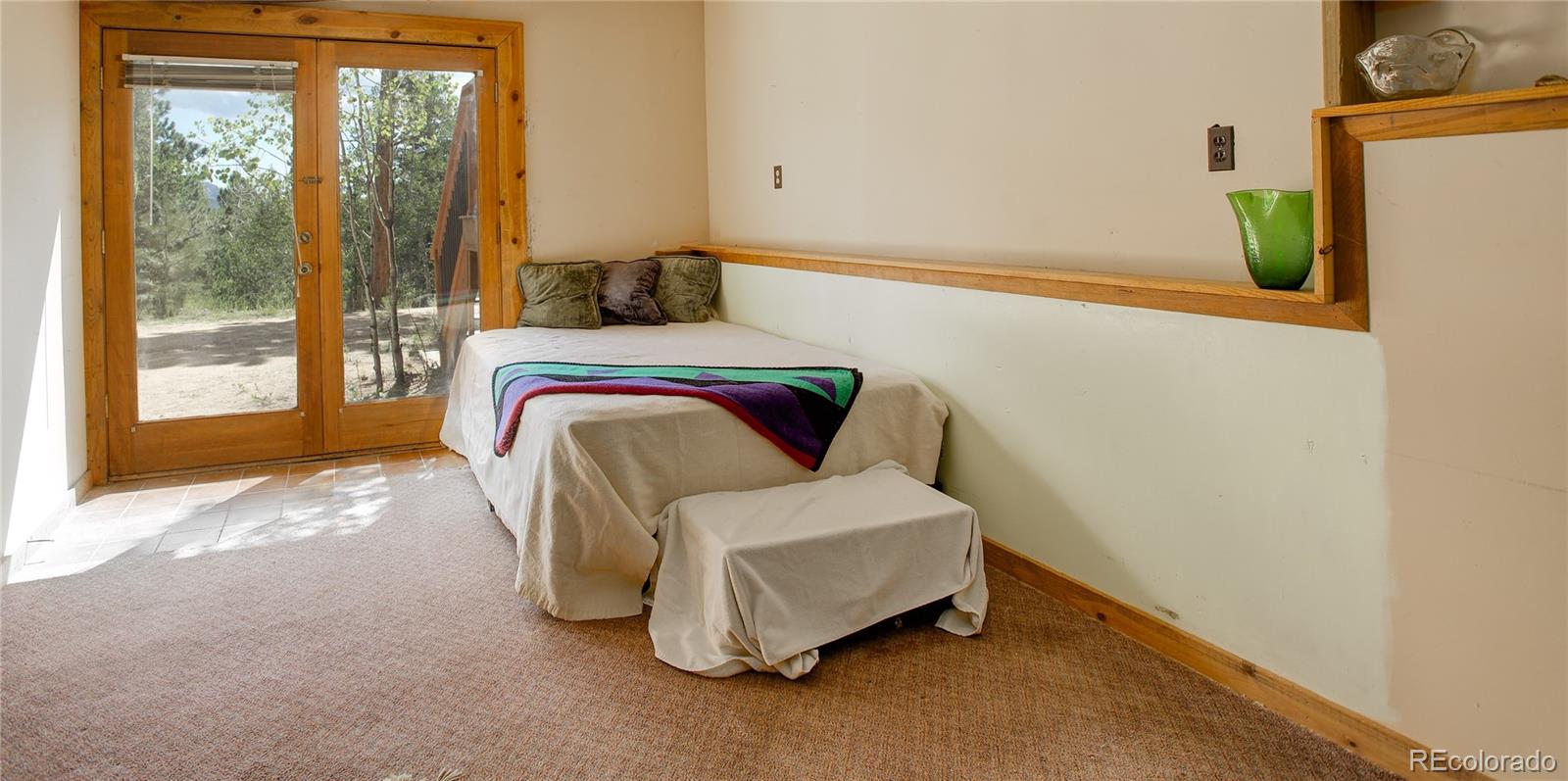 77 East Crosscut Road Bailey, CO 80421 - Photo 38 of 43 a bedroom with a bed and a window