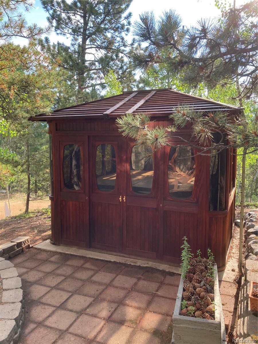 77 East Crosscut Road Bailey, CO 80421 - Photo 6 of 43 a view of a house with a tree
