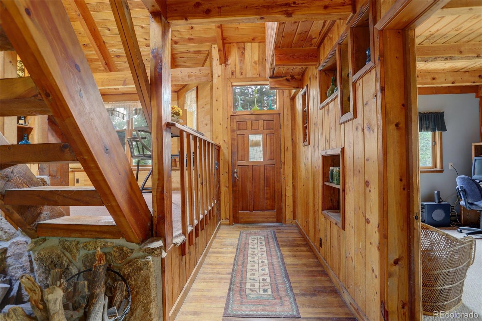 77 East Crosscut Road Bailey, CO 80421 - Photo 7 of 43 a view of a balcony with wooden floor and stairs