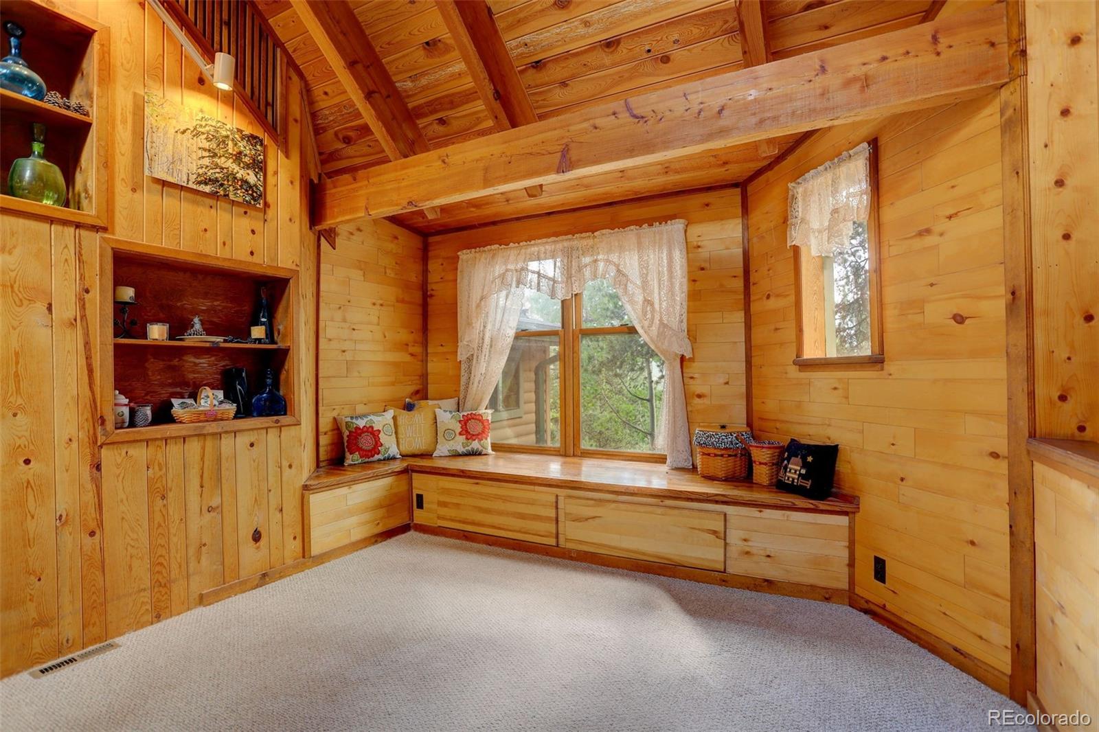 77 East Crosscut Road Bailey, CO 80421 - Photo 8 of 43 a swimming pool with outdoor seating and yard