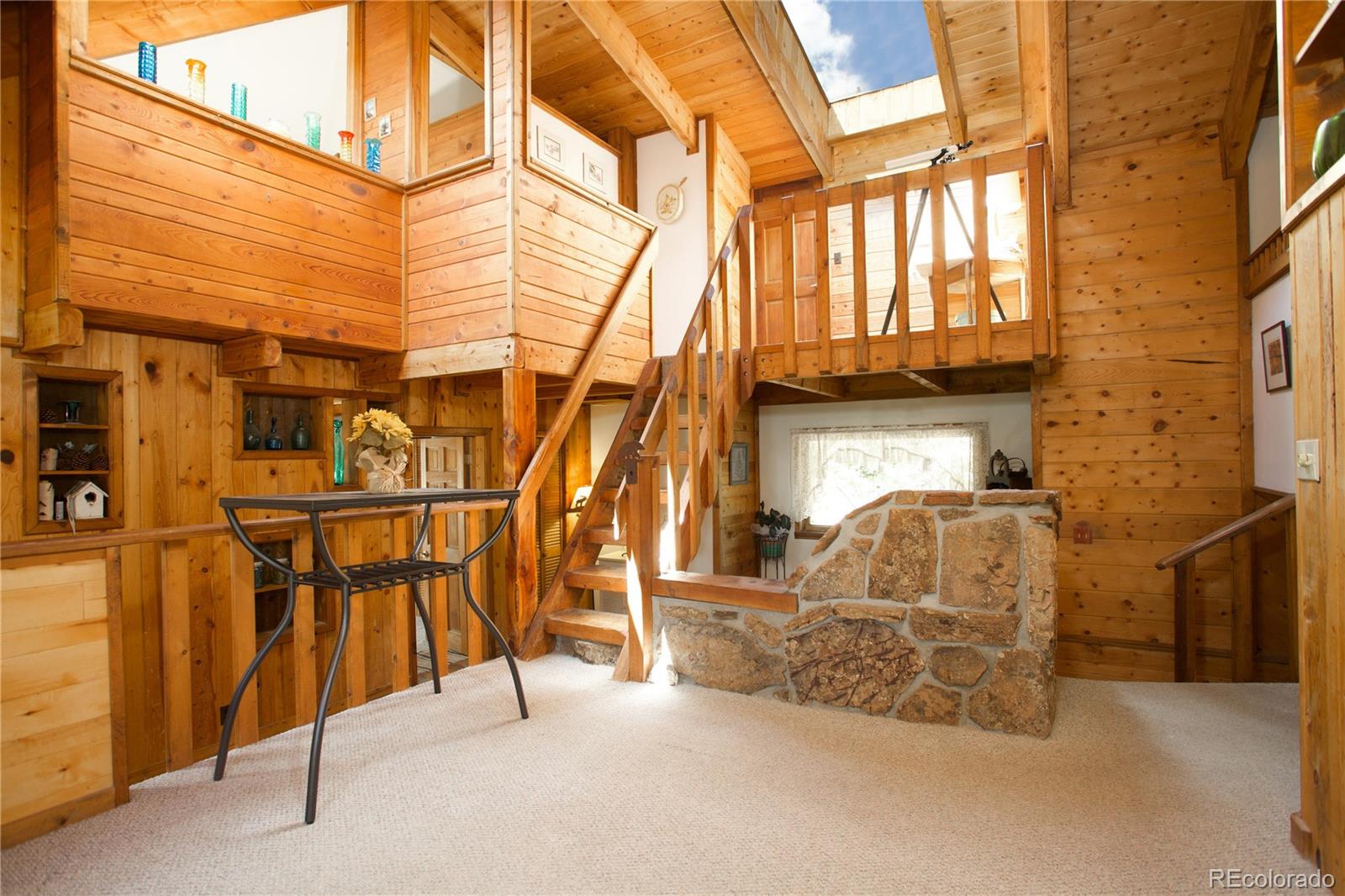 77 East Crosscut Road Bailey, CO 80421 - Photo 10 of 43 a roof deck with table and chairs