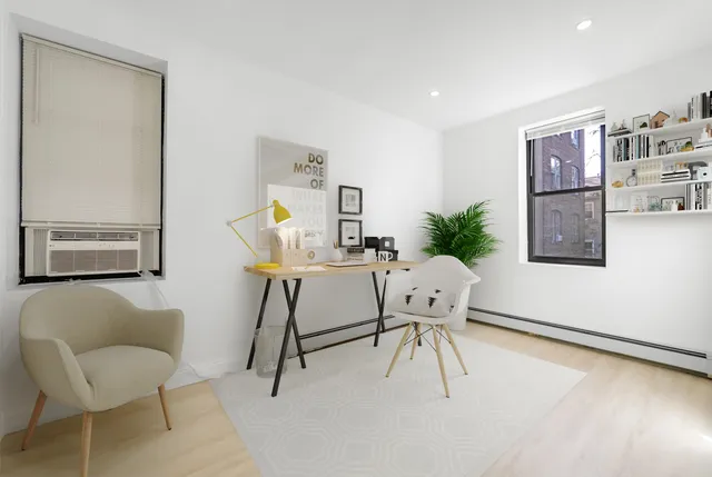a workspace with furniture and a potted plant