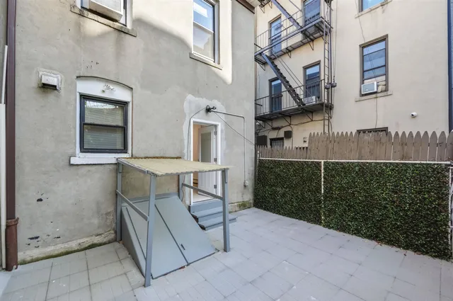 a view of a brick house with many windows