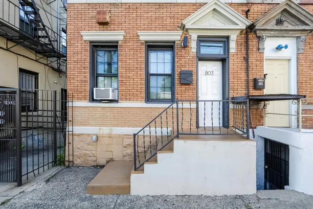 a view of a brick house with large windows
